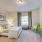 Large well lit bedroom with plush carpets and large windows 