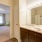 Large well lit bathroom with white accents 