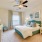 Large well lit bedroom with plush carpets and large windows 